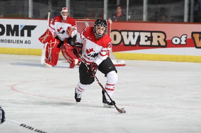 Tessa carries the puck up ice during a game at last year's women's world hockey championships. Photography by Andre Ringuette – HHOF/IIHF Images (courtesy of Hockey Canada)