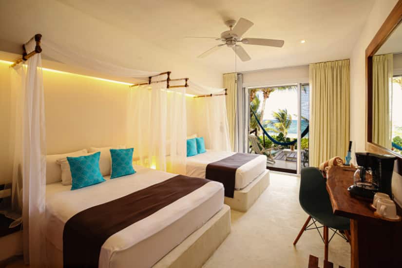 A deluxe room with two queen beds and beach access at Cabanas Hotel