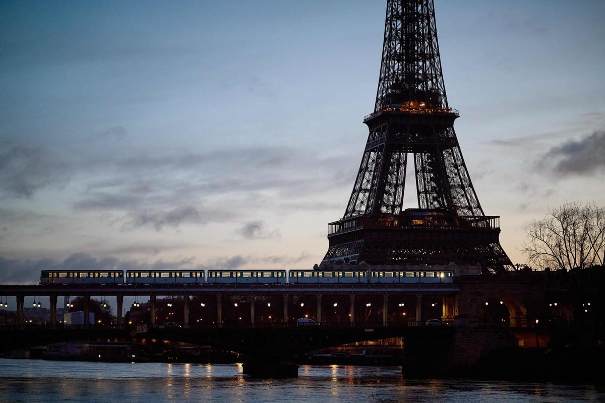 A Paris metro line train crosses the Seine in front of the Eiffel Tower, February 23, 2024