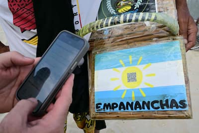 A man pays for a purchase on Copacabana Beach using Brazil's Pix instant payment system, in Rio de Janeiro, July 9, 2026.
