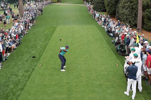 On the 18th tee, Tiger Woods performs under the admiring gaze of golf fans who followed in his footsteps at Augusta National on Friday.