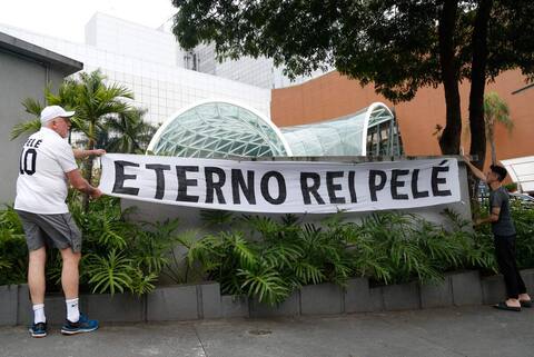 At the gates of the hospital where Pele died, his admirers mourn theirs