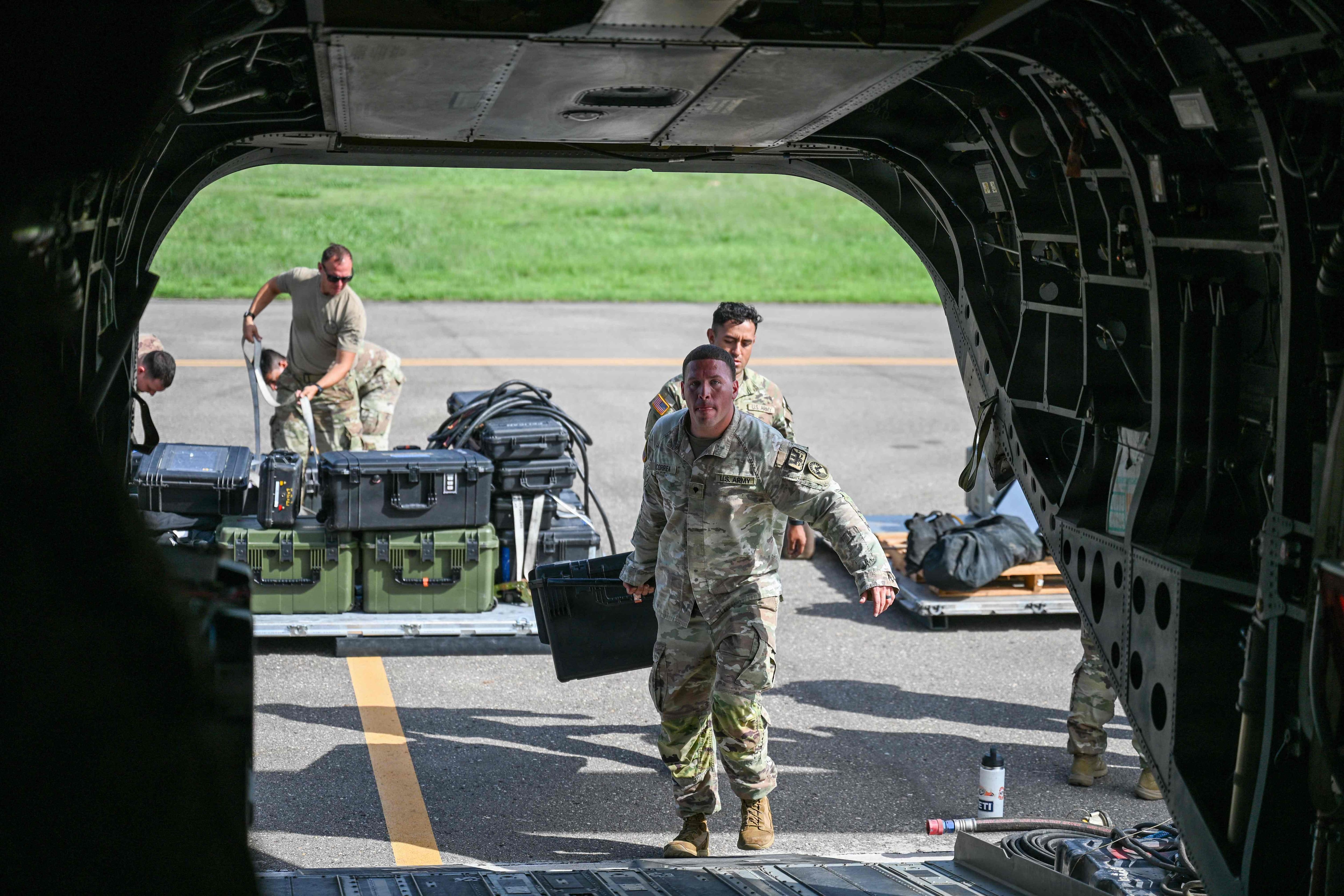 Members of Joint Task Force Bravo load equipment onto a CH-47 Chinook in support of relief operations in Venezuela, at Soto Cano Air Base near Comayagua, Honduras, June 25, 2026.