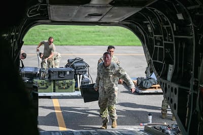 Members of Joint Task Force Bravo load equipment onto a CH-47 Chinook in support of relief operations in Venezuela, at Soto Cano Air Base near Comayagua, Honduras, June 25, 2026.