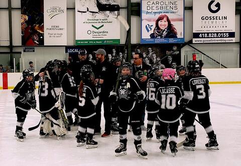 The Husky players celebrate following a victory in overtime during the semi-final of the regional championships at the Boischatel arena.