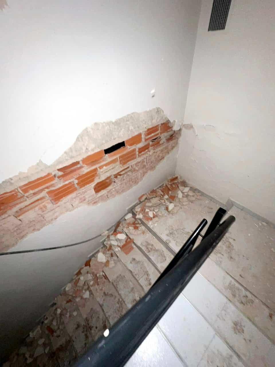 The stairs of Carlos Burgues' girlfriend's building were covered in fragments after the double earthquake.