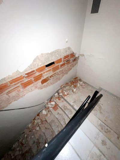 The stairs of Carlos Burgues' girlfriend's building were covered in fragments after the double earthquake.
