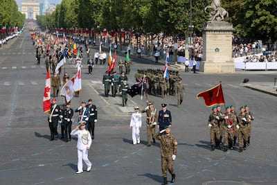 Troops from the Coalition of Volunteers from invited foreign nations participate in the annual Bastille Day military parade on Avenue des Champs-Élysées in Paris, July 14, 2026.