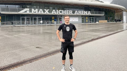 The athlete proudly poses in front of the Max Aicher Arena.