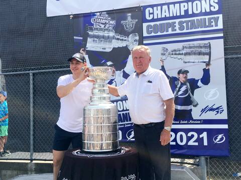 Annie Gourde presents the Stanley Cup to Saint-Narcis-de-Buriges Mayor Dennis Dion, who thanked the village sports center for changing its name in honor of the hockey player.