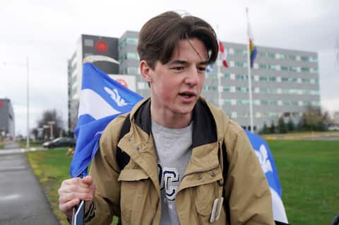 Matthew Hull, 18, is seen waving the Quebec flag.