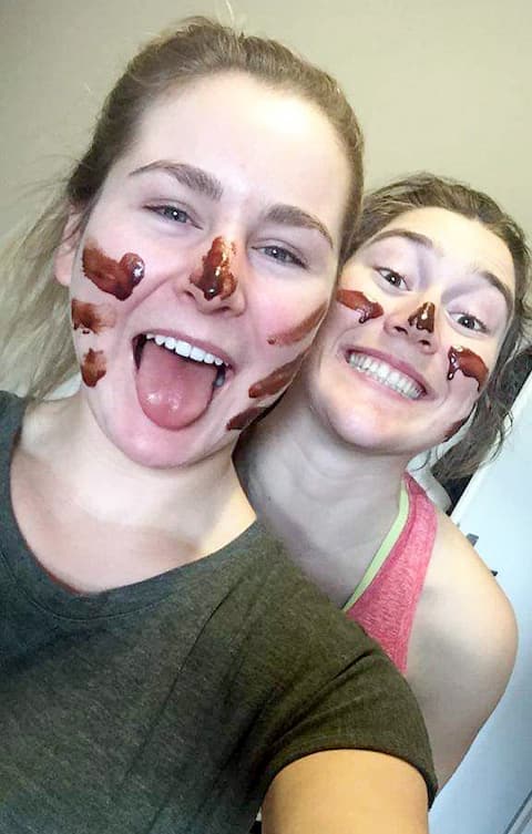 Laurence St-Germain and Valérie Grenier with chocolate on their faces after preparing dessert.