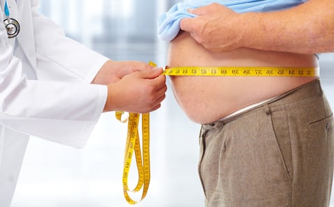 Ozempic Semaglutide Injection Diabetes Drug Being Used For Weight Loss. A Woman Holding an Ozempic Injection Pen in Front of Her Stomach.