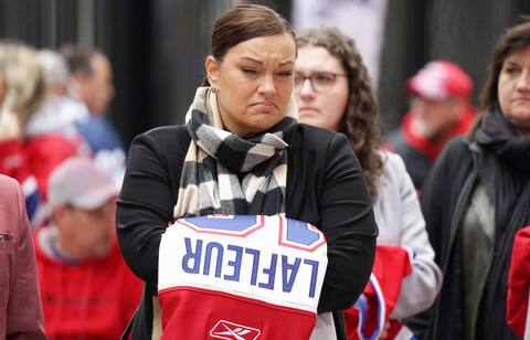 This fan, holding the No. 10 shirt in her hands, looked emotional.