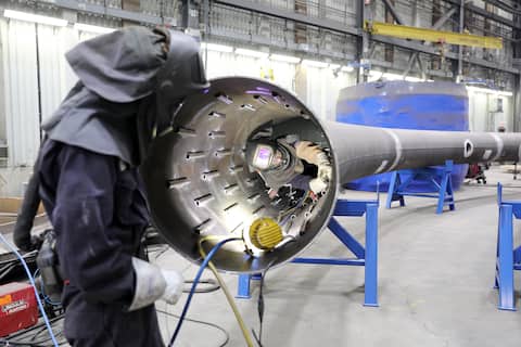 Factory personnel must wear special masks so that they can weld inside the structure.