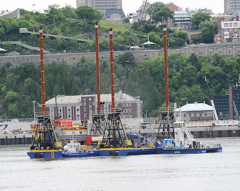 In this picture taken on July 14, a special barge is anchored in the river above the Quebec-Lévis crossing to dredge the St. Lawrence bed.