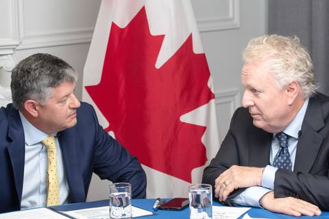 Conservative Party of Canada leadership candidates Scott Aitchison and Jean Charest chat quietly before Wednesday night's debate.