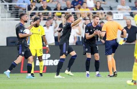 CF defender Joel Waterman disputes the referee's decision to show him a yellow card in the first half.