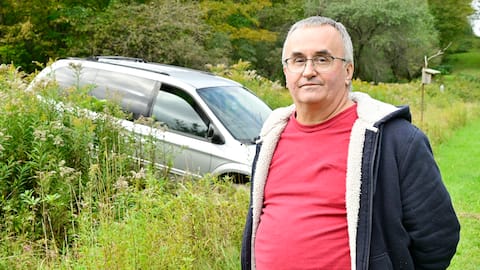 André LaBelle thought he was enjoying a peaceful retirement on his estate in Saint-Armand, but the refugees ruined his plans. An abandoned vehicle can be seen directly behind him on the border between Canada and the United States.