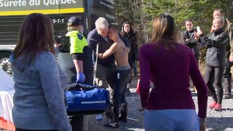A 21-year-old hugs his father after leaving the forest without a sweater because of the heat.
