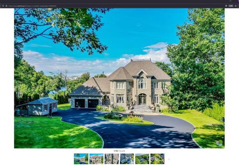 The grounds of the residence serve as a small garden along the Saint-Maurice River.