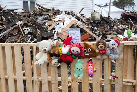 Holy Basil Fire Dogs, flowers and photographs were left at the site.