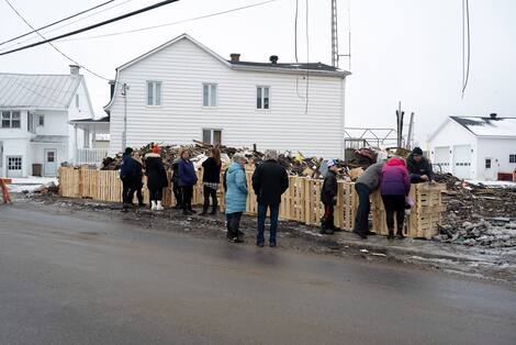 st-basile fire Relatives of the three victims gathered in front of the wreckage to pray on Tuesday.