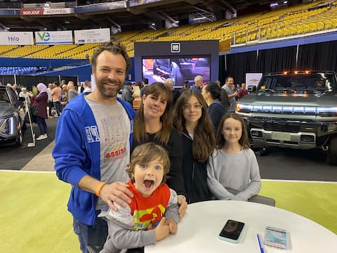 Julien Chaumont (right), his spouse, Laurence Le Guillaume, and their three children (Raphaelle, Beatrice and Mathieu) visit the Montreal Electric Vehicle Show at the Olympic Stadium on April 22, 2023. Photo by Audrey Robitaille