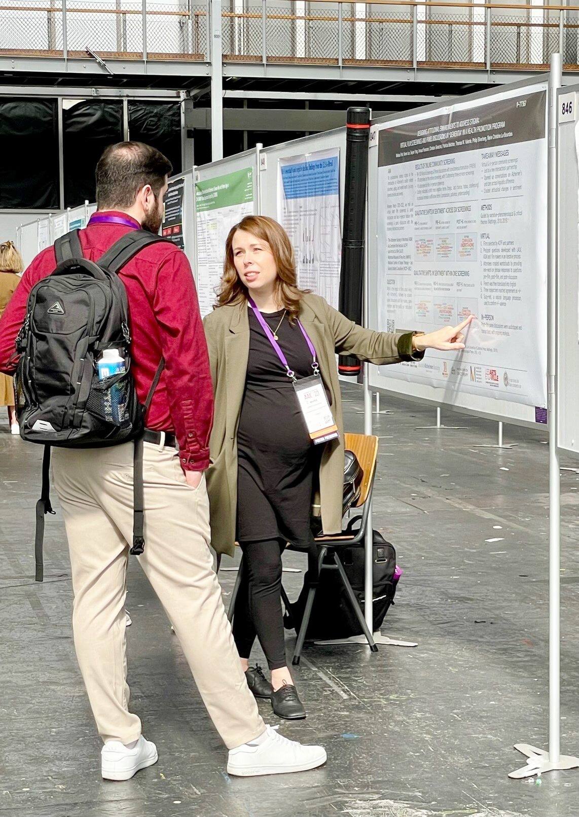 MRI of head of elderly woman in hands of doctor standing in medical ward near senior patient with relative and nurse. Recovery following a stroke