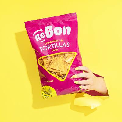 People eating tasty corn chips at white table