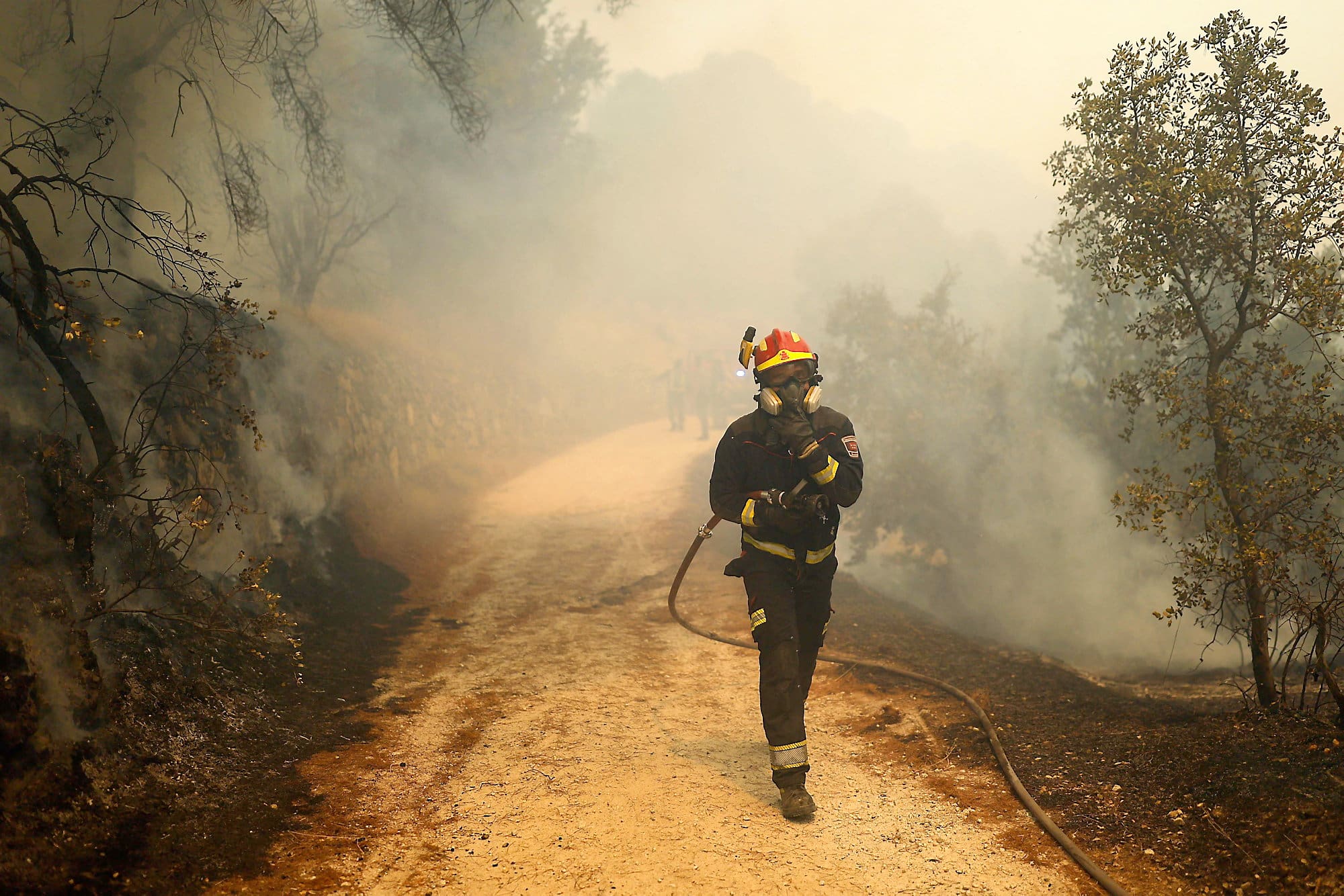 A firefighter fighting fires near the Spanish capital.