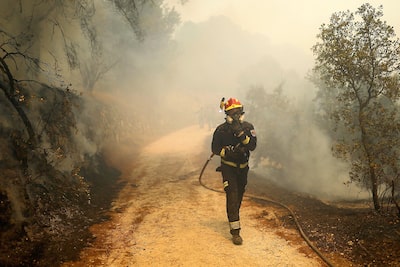 A firefighter fighting fires near the Spanish capital.