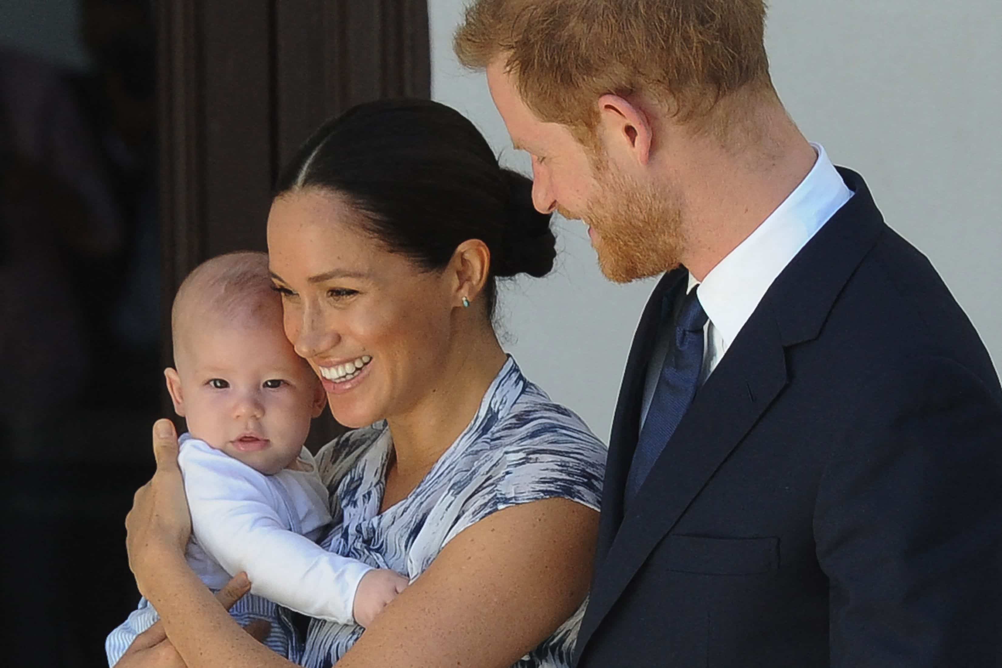 ) The Duke and Duchess of Sussex, Prince Harry and his wife Meghan, hold their son Archie during a meeting with Archbishop Desmond Tutu and his wife at the Tutu Legacy Foundation in Cape Town on September 25, 2019.