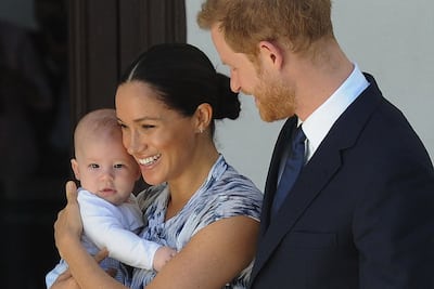 ) The Duke and Duchess of Sussex, Prince Harry and his wife Meghan, hold their son Archie during a meeting with Archbishop Desmond Tutu and his wife at the Tutu Legacy Foundation in Cape Town on September 25, 2019.
