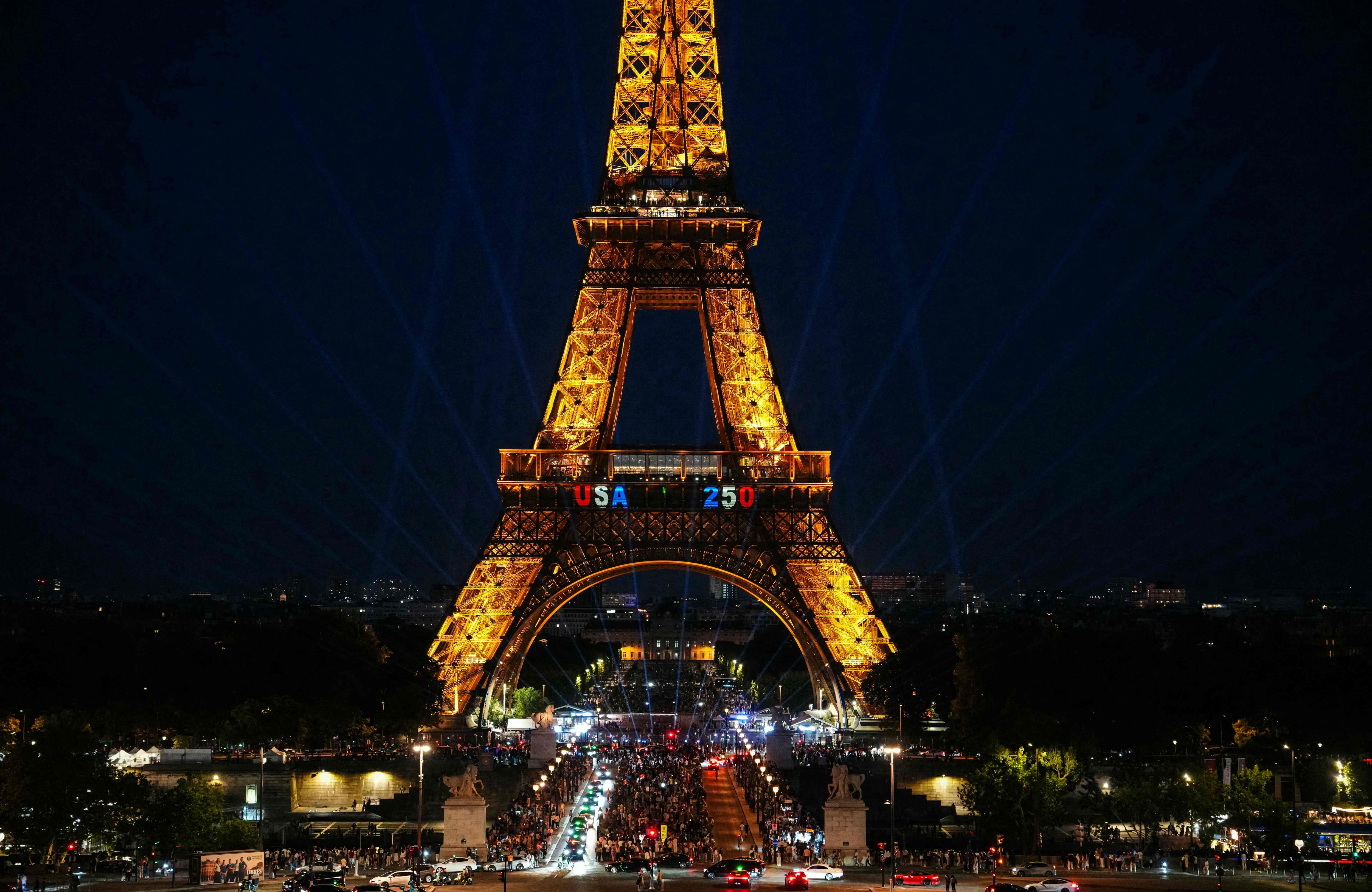 Man climbs Eiffel Tower and hangs American flag
