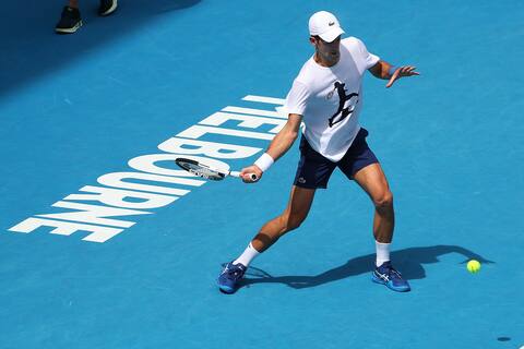 Djokovic trains at Australian Open, participation still pending
