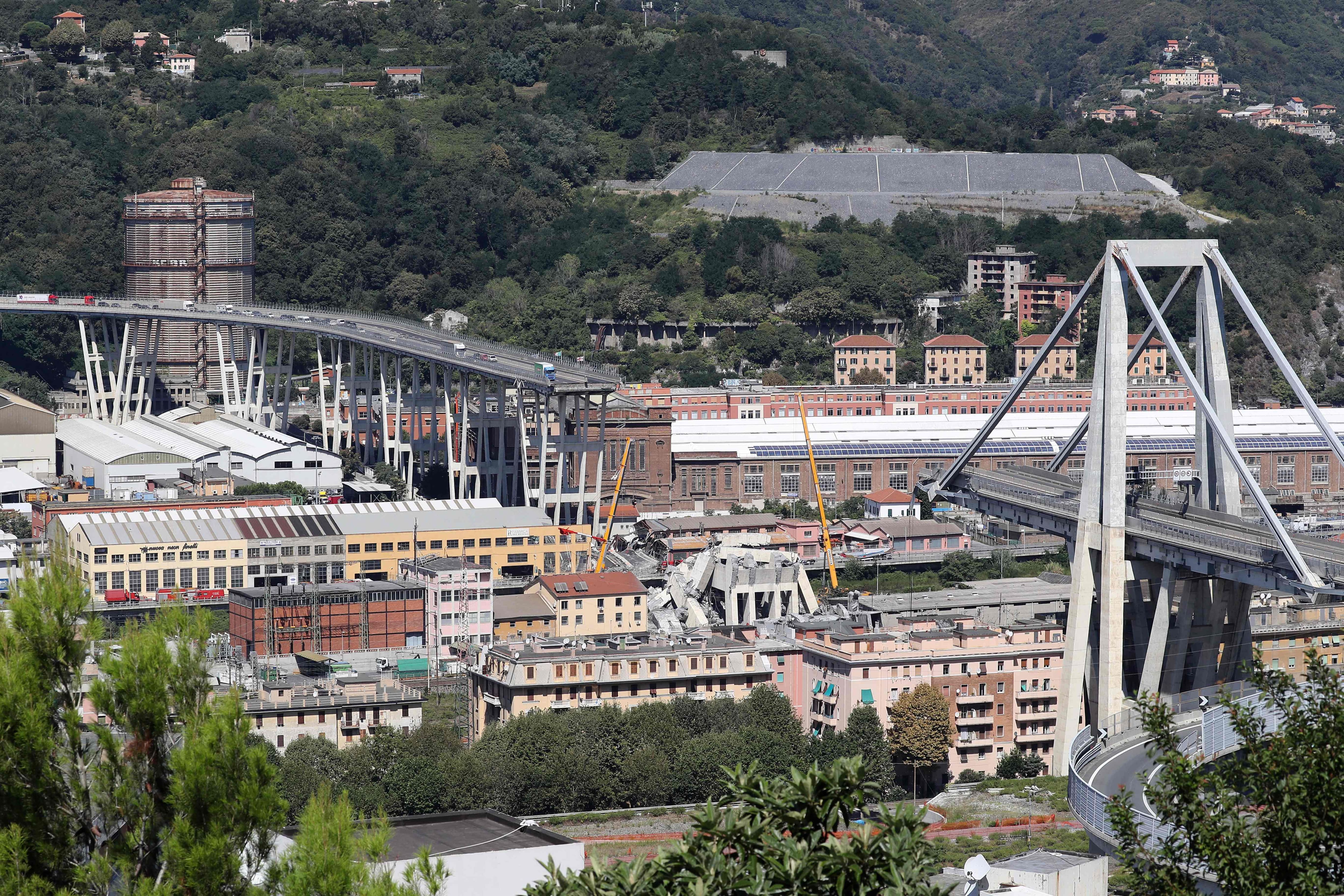 This overview taken on August 15, 2018 shows abandoned vehicles on the Morandi motorway bridge, the day after part of it collapsed in the northwestern Italian city of Genoa.