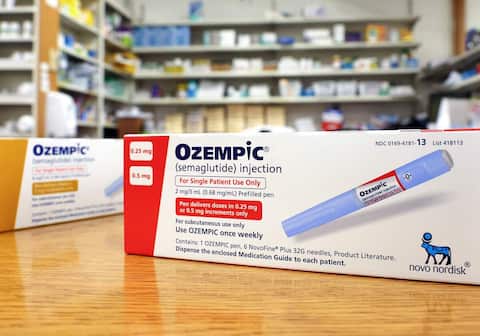 Ozempic Semaglutide Injection Diabetes Drug Being Used For Weight Loss. A Woman Holding an Ozempic Injection Pen in Front of Her Stomach.