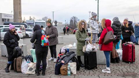 Ukrainian citizens fleeing the conflict arrive on foot at the Medyka border in eastern Poland on Sunday.