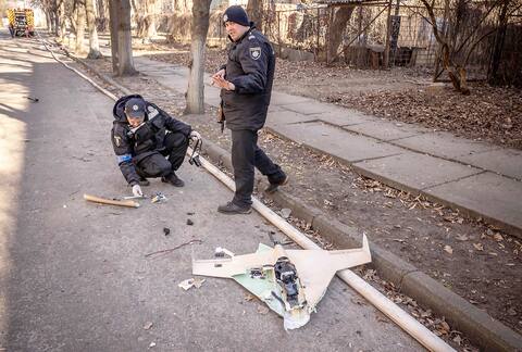 Ukrainian police inspect one of the drones that crashed.