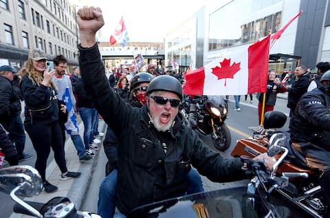 One of the protesting motorcyclists raised his fist.