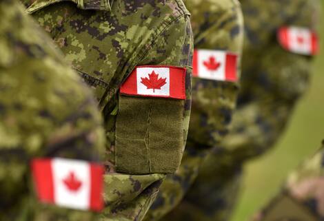 Canada sticks flags in the hands of soldiers. Canadian troops Canada sticks flags in the hands of soldiers. Canadian troops
