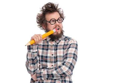 Crazy bearded man with big pencil
