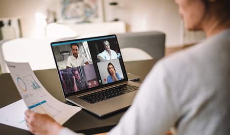 Woman discussing business with team over a video conference Woman discussing business with team over a video conference