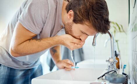 バスルームの男、歯を磨き、水ですすぎ、家の健康と健康のための朝の掃除ルーチン。歯科治療、うがい薬、歯ブラシ、新鮮な呼吸と口腔衛生のための男性のグルーミング。 バスルームの男、歯を磨き、水ですすぎ、家の健康と健康のための朝の掃除ルーチン。歯科治療、うがい薬、歯ブラシ、新鮮な呼吸と口腔衛生のための男性のグルーミング。