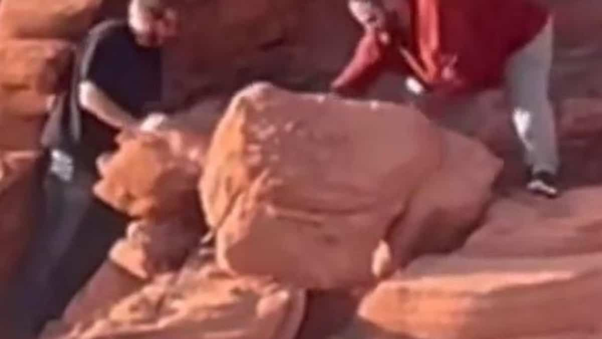 Two visitors destroy ancient rock formations at a protected site