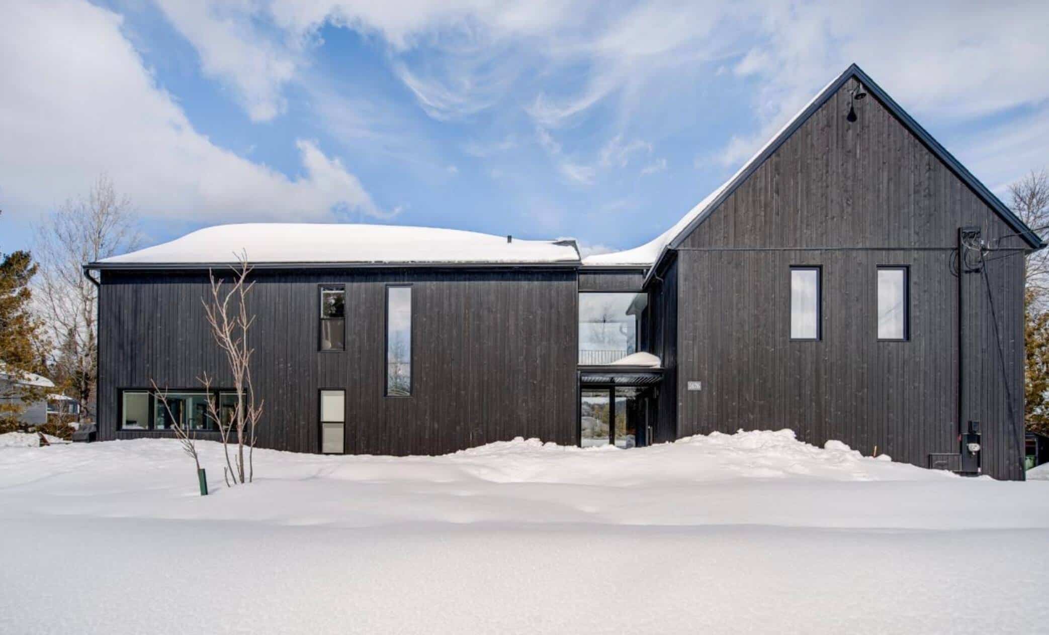 An allblack Scandinavian home on the waterfront in SaintAdolphed