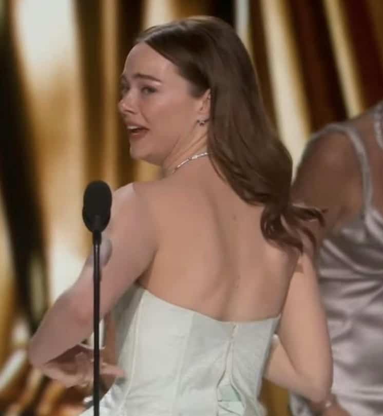 Emma Stone monte sur scène avec une robe brisée