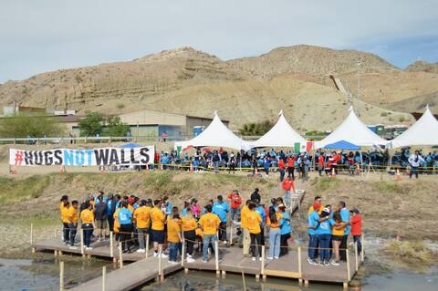 Families gathered under the scorching sun in the middle of the Rio Grande River, which separates the United States from Mexico.