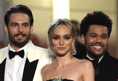 Director Sam Levinson with Lily-Rose Depp and The Weeknd on the red carpet.